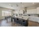 Bright, open kitchen with island seating, quartz countertops, stainless hood, and wood-look tile at 3310 E Los Gatos Dr, Phoenix, AZ 85050