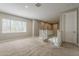 Spacious loft area with plush carpeting, large windows, and a view of the downstairs living area at 3310 E Los Gatos Dr, Phoenix, AZ 85050