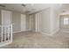 Large carpeted loft with white trim and neutral paint, offering versatility for various uses at 3310 E Los Gatos Dr, Phoenix, AZ 85050