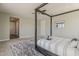 Main bedroom with four-poster bed, stylish rug, and neutral colors at 3310 E Los Gatos Dr, Phoenix, AZ 85050