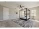 Spacious main bedroom featuring a four-poster bed, ceiling fan, and neutral decor at 3310 E Los Gatos Dr, Phoenix, AZ 85050