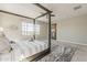 Bright bedroom with a four-poster bed, modern decor, and large windows at 3310 E Los Gatos Dr, Phoenix, AZ 85050