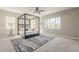 Main bedroom showcasing a modern canopy bed, a patterned rug, and bright, natural light at 3310 E Los Gatos Dr, Phoenix, AZ 85050