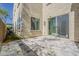 Cozy outdoor patio features stone pavers, a sliding glass door, and a small patch of green space at 3310 E Los Gatos Dr, Phoenix, AZ 85050
