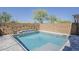 Beautiful backyard pool with tanning ledge, surrounded by a brick wall and desert landscaping at 3310 E Los Gatos Dr, Phoenix, AZ 85050