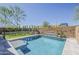 Well-maintained pool with tanning ledge set against manicured landscaping and brick wall at 3310 E Los Gatos Dr, Phoenix, AZ 85050