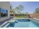 Resort-style pool with tanning ledge, framed by lush landscaping and a covered patio at 3310 E Los Gatos Dr, Phoenix, AZ 85050