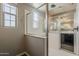 Shower featuring glass doors, tiled walls, and modern fixtures at 3310 E Los Gatos Dr, Phoenix, AZ 85050