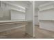 Spacious walk-in closet featuring custom shelving and ample storage space, perfect for organization and convenience at 3310 E Los Gatos Dr, Phoenix, AZ 85050