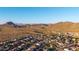 Scenic aerial view of a desert community with mountain views, showcasing homes and the beautiful Arizona landscape at 3715 W Teresa Dr, New River, AZ 85087