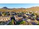 Aerial view of the neighborhood and surrounding desert landscape with mountain views at 3715 W Teresa Dr, New River, AZ 85087