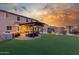 Inviting backyard with an outdoor kitchen, a turf lawn, a pergola, and views of the mountains at 3715 W Teresa Dr, New River, AZ 85087