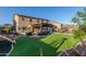 Expansive backyard featuring a covered patio, built-in grill, lush artificial turf, and mountain views at 3715 W Teresa Dr, New River, AZ 85087