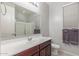 A bathroom boasts neutral paint, a white sink, and a glass walk-in shower at 3715 W Teresa Dr, New River, AZ 85087