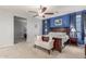 A primary bedroom features a ceiling fan, a wooden bed frame, and blue accent wall with access to a room at 3715 W Teresa Dr, New River, AZ 85087