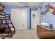 Sports themed bedroom with a bunk bed, playful wall art, and neutral carpet at 3715 W Teresa Dr, New River, AZ 85087