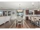 Bright dining room featuring a chandelier, dining table with seating for six, and access to the backyard at 3715 W Teresa Dr, New River, AZ 85087