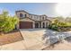 Stunning two-story home featuring a three-car garage, desert landscaping, and a spacious driveway at 3715 W Teresa Dr, New River, AZ 85087