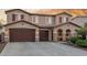 Beautiful two-story home featuring a three-car garage, stone accents, and desert landscaping at 3715 W Teresa Dr, New River, AZ 85087