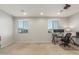 Spacious loft featuring neutral carpets, recessed lighting, work desks, and natural light from windows at 3715 W Teresa Dr, New River, AZ 85087