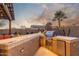This outdoor kitchen area features a built-in grill, fire pit, and bar seating at 3715 W Teresa Dr, New River, AZ 85087
