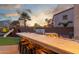This outdoor kitchen area has a built-in grill, fire pit, bar, and bar stool seating at 3715 W Teresa Dr, New River, AZ 85087