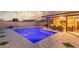 Backyard view featuring pool, covered patio with seating area, and artificial turf at 3715 W Teresa Dr, New River, AZ 85087