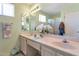 Bathroom with dual sinks, large mirror, and updated lighting fixtures at 3755 N 151St Ave, Goodyear, AZ 85395