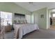 Bright bedroom with high ceilings, mint walls, and a large window providing ample natural light at 3755 N 151St Ave, Goodyear, AZ 85395
