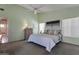 Spacious bedroom featuring soft green walls, a ceiling fan, and carpeted floors at 3755 N 151St Ave, Goodyear, AZ 85395