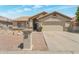 Inviting single story home with desert landscaping and a two-car garage at 3755 N 151St Ave, Goodyear, AZ 85395