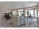 Open kitchen flows to dining area with large windows and a spacious breakfast nook at 3755 N 151St Ave, Goodyear, AZ 85395