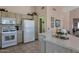 Classic kitchen with white appliances, neutral cabinets, and a view into the living area at 3755 N 151St Ave, Goodyear, AZ 85395