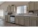 Well-lit kitchen with plenty of cabinet space and a stainless steel sink beneath a large window at 3755 N 151St Ave, Goodyear, AZ 85395