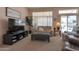 Cozy living room featuring plush seating, a large window, and a modern television at 3755 N 151St Ave, Goodyear, AZ 85395