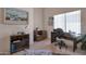 Well-lit home office with a view, desk space, shelving, and a hide rug at 3755 N 151St Ave, Goodyear, AZ 85395