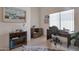 Well-lit home office with a view, desk space, shelving, and a hide rug at 3755 N 151St Ave, Goodyear, AZ 85395
