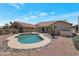 Backyard pool with rock features, desert landscaping, and a view of the home at 3755 N 151St Ave, Goodyear, AZ 85395