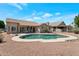 A backyard pool with rock border, desert landscaping, and a covered patio area at 3755 N 151St Ave, Goodyear, AZ 85395