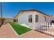 Landscaped backyard with synthetic grass and a white picket fence at 39 N Maple St, Mesa, AZ 85205