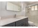 Bathroom featuring a gray vanity, white marble countertops, modern mirror, and glass-enclosed shower at 39 N Maple St, Mesa, AZ 85205