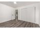 Bedroom featuring vinyl plank flooring, ceiling fan, closet space, and ample natural light at 39 N Maple St, Mesa, AZ 85205