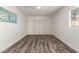 Neutral bedroom with luxury vinyl plank flooring, ceiling fan, and closet at 39 N Maple St, Mesa, AZ 85205