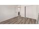 Bedroom with vinyl plank flooring with open door to bathroom at 39 N Maple St, Mesa, AZ 85205