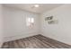 Bright bedroom featuring hard surface floors, a ceiling fan, and natural light at 39 N Maple St, Mesa, AZ 85205