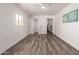 Spacious bedroom with luxury vinyl plank flooring leading to bathroom and laundry at 39 N Maple St, Mesa, AZ 85205