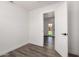 Bedroom with vinyl plank flooring with open door to lush front yard at 39 N Maple St, Mesa, AZ 85205