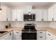 Bright kitchen with white cabinetry, stainless steel appliances, and butcher block countertops at 39 N Maple St, Mesa, AZ 85205