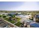 An aerial view of a community including a pool, park, and lake at 4083 E Rustler Way, Gilbert, AZ 85297