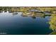 Aerial view of the community lake with covered picnic area, walking path, and lush greenery at 4083 E Rustler Way, Gilbert, AZ 85297